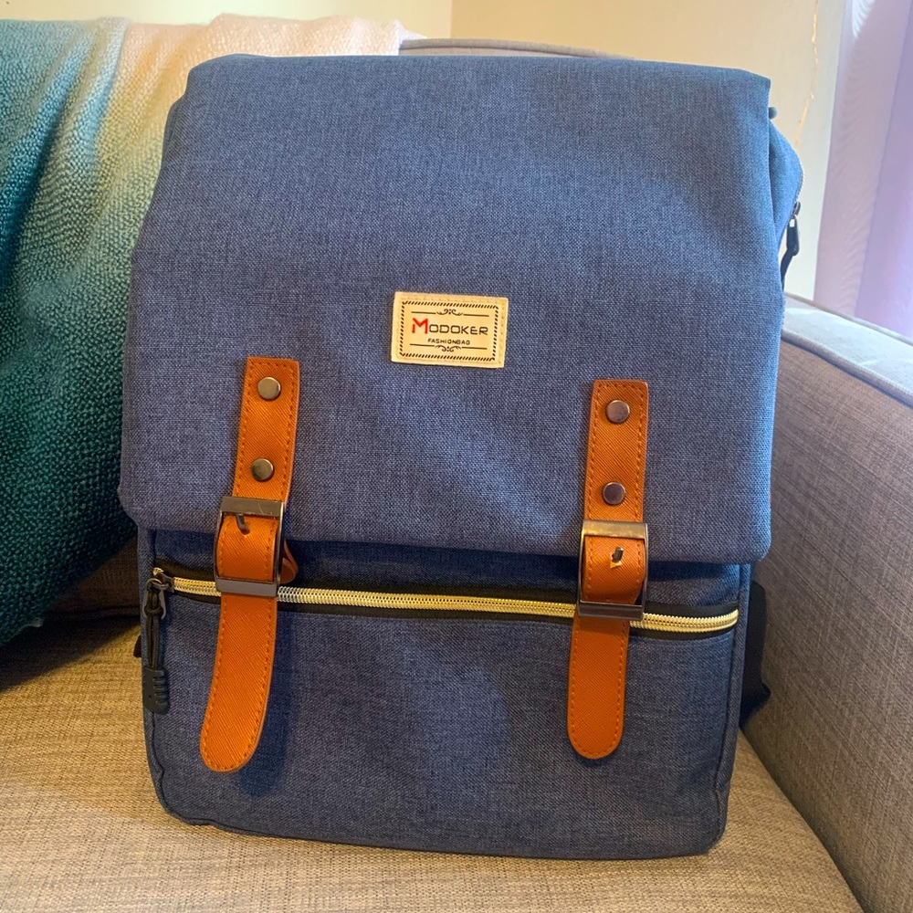 Blue backpack with buckle straps and laptop pouch